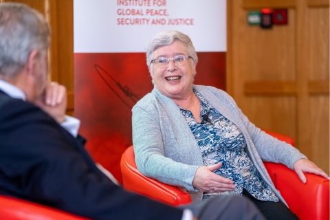 A lady sitting in a red chair