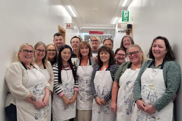 Group photo of CONNECT members of staff in their aprons
