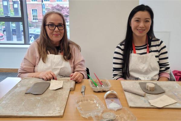 Smiling staff working with clay