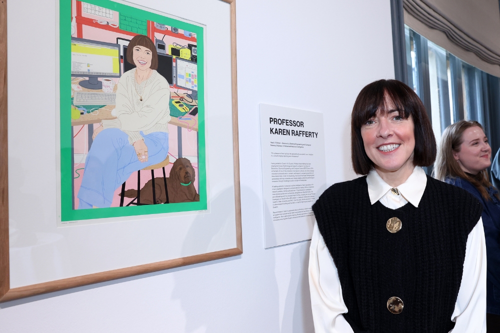 Nominee Karen Rafferty standing in front of her portrait in the Naughton Gallery