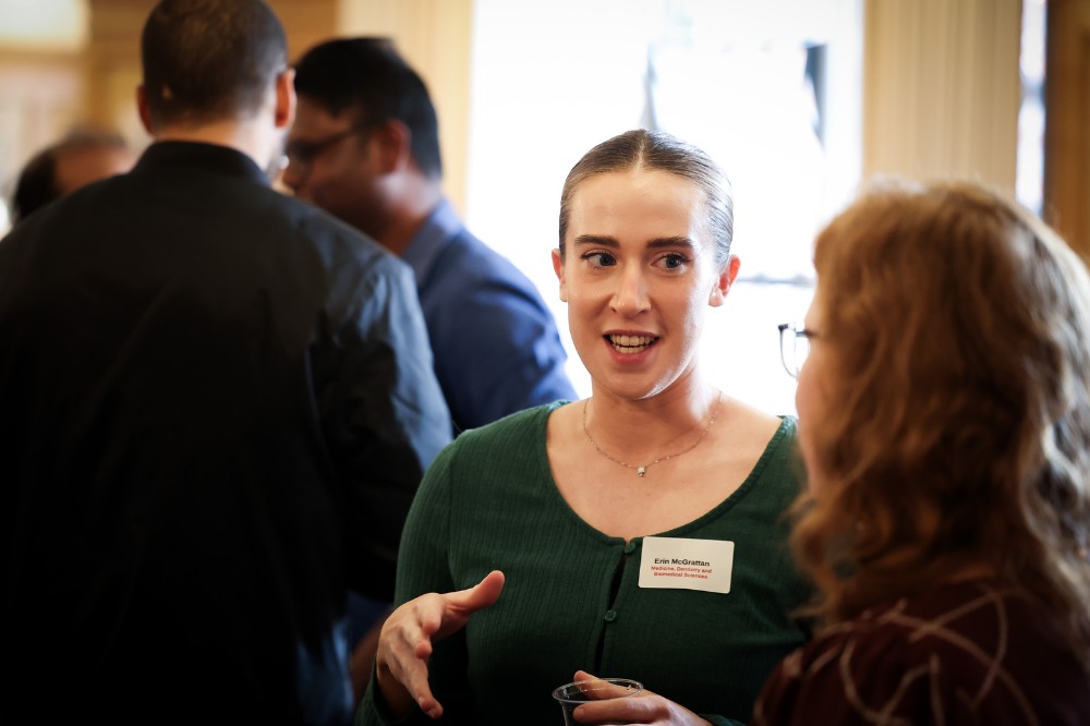 woman conversing with another at an indoor event
