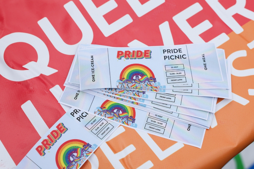 free meal or ice-cream tickets set on a rainbow-coloured Queens University Belfast tablecloth