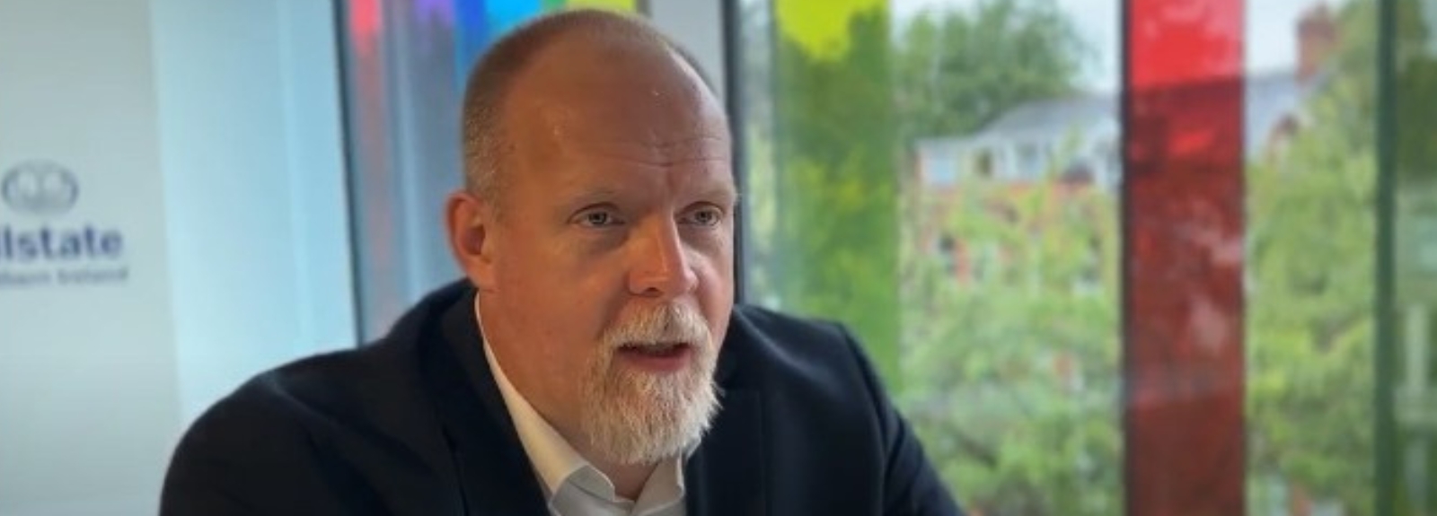 Man speaking directly to the camera, conveying a message.