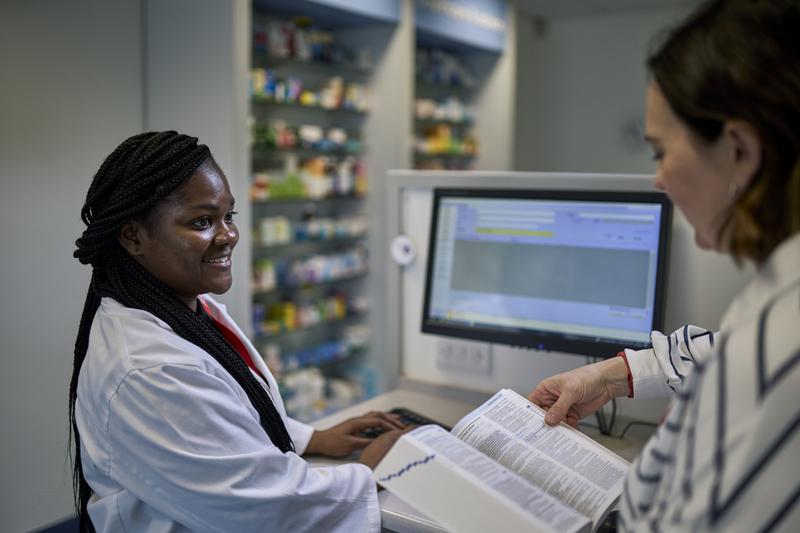 Two researchers look at results on computer screen
